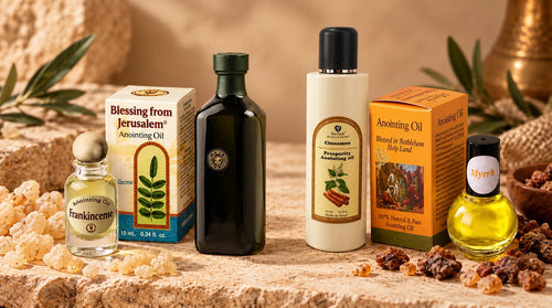 Frankincense and Myrrh anointing oil bottles displayed side by side with their original packaging on a natural beige background.