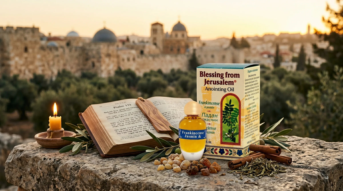 Jerusalem anointing oil bottle beside an open Bible, olive branches, and candle overlooking the Holy City in warm golden light.