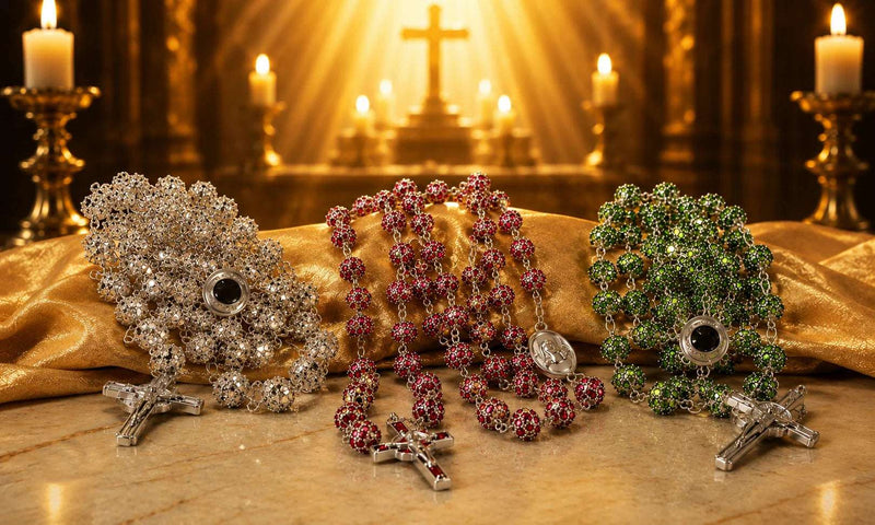 Crystal rosaries with silver, red, and green beads featuring crucifixes and devotional medals displayed in a church-inspired setting.