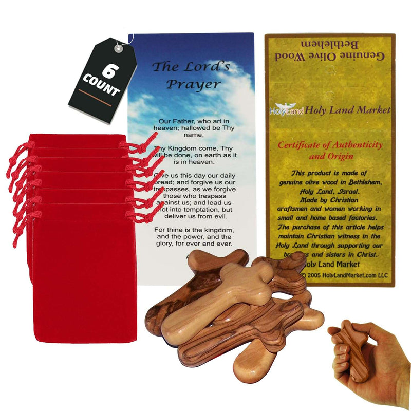 Six Bethlehem olive wood comfort holding crosses with red velvet bags