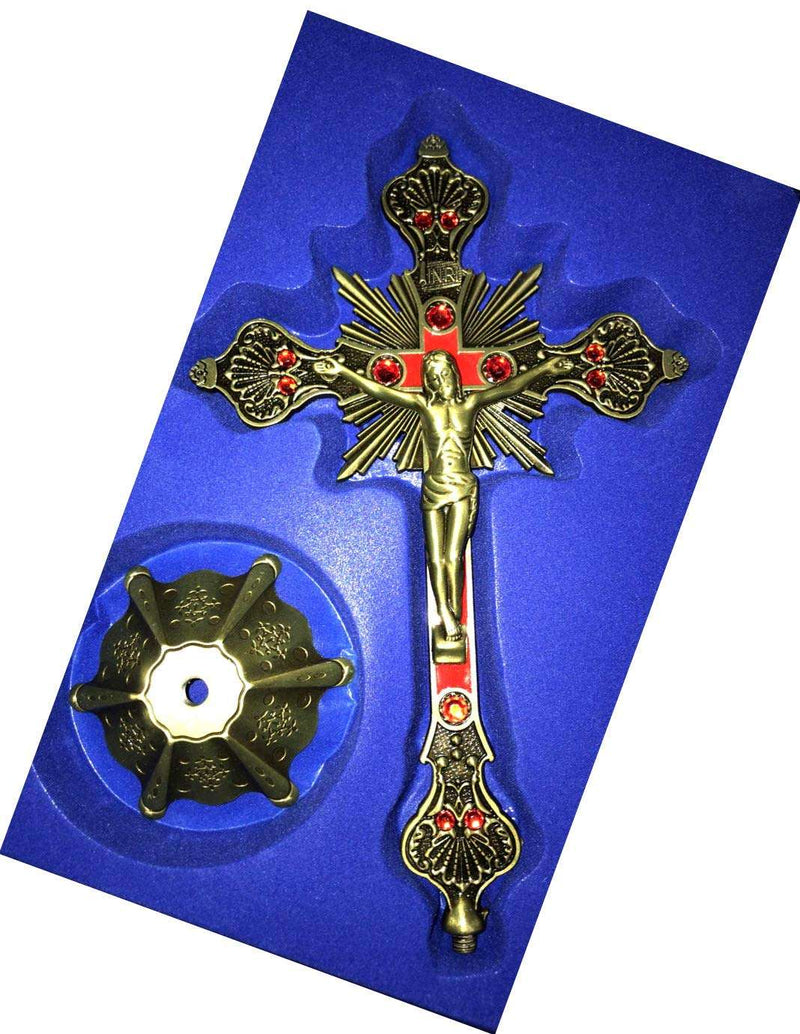 Antique brass crucifix with red enamel and red stones in blue foam packaging