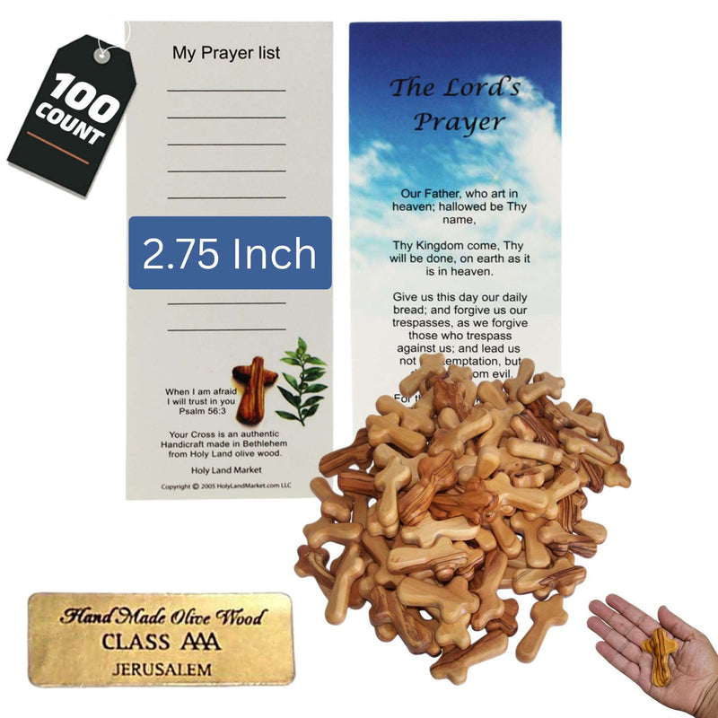 Heap of one hundred olive wood pocket crosses with prayer cards