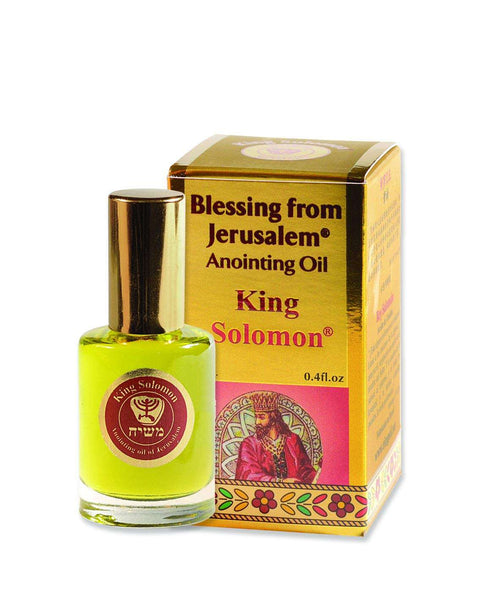 Gold box with pink panel of enthroned king, beside green-gold oil bottle #material type_king solomon