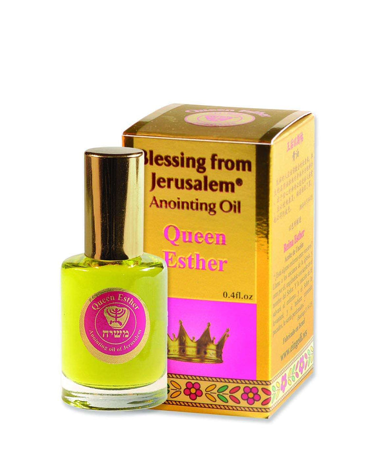 Gold box with magenta panel and crown, beside gold-capped oil bottle